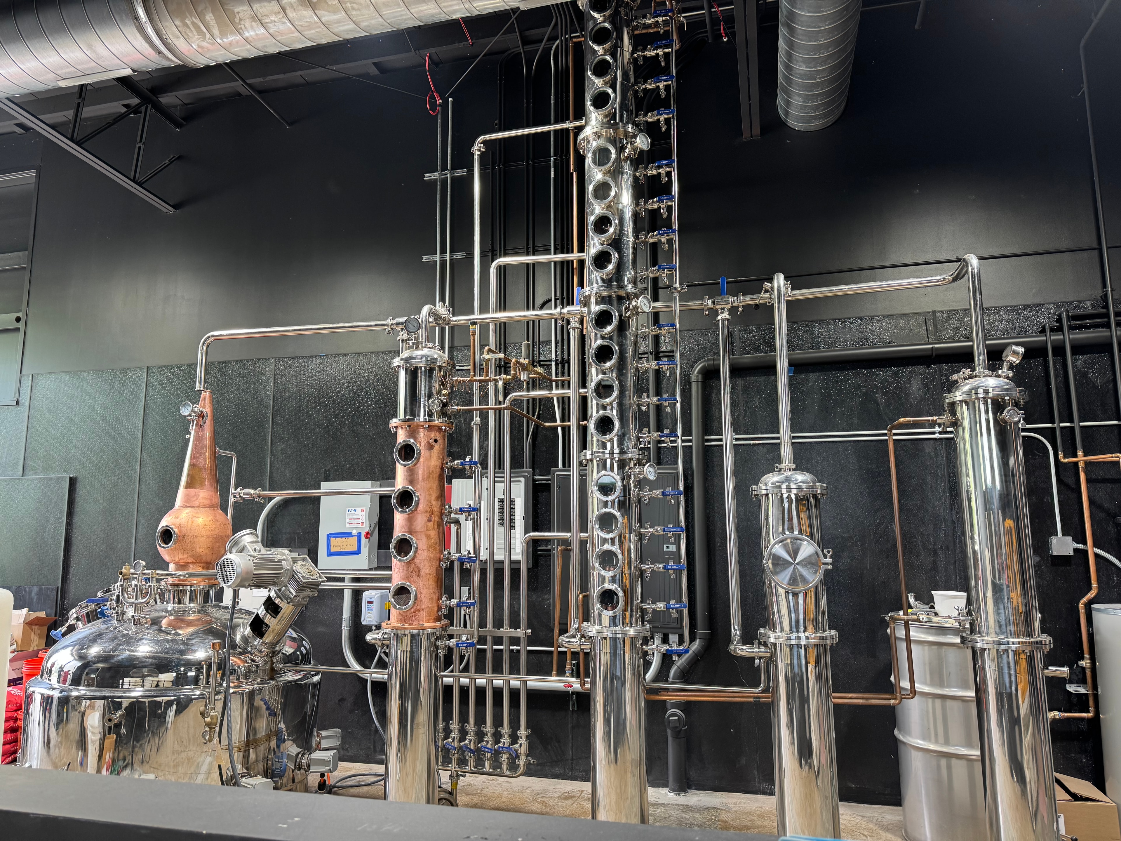 The copper pot still and stainless distillation columns inside the Black Dog distillery